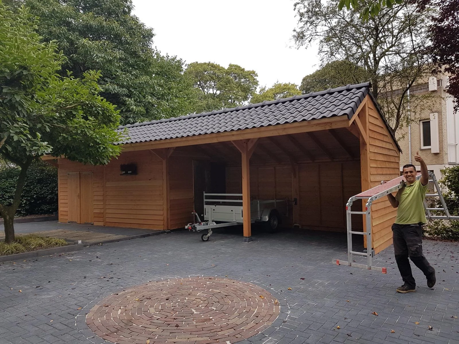 De kapschuur tijdens de bouw, met de timmerman aan het werk